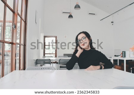 Beautiful young asian woman sitting in a cafe
