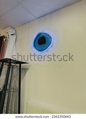 Evil eye neon sign on wall