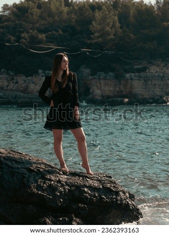person on the rocks sea