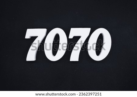 Black for the background. The number 7070 is made of white painted wood.