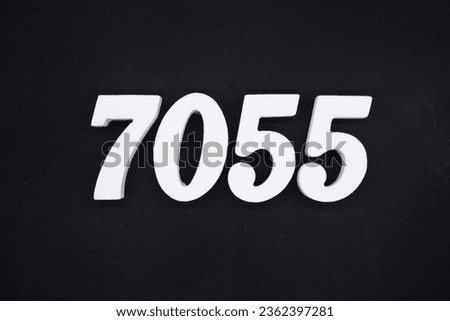 Black for the background. The number 7055 is made of white painted wood.