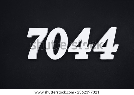 Black for the background. The number 7044 is made of white painted wood.