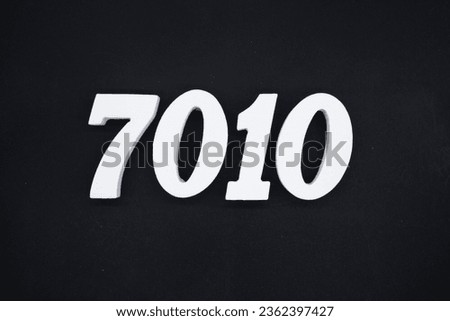 Black for the background. The number 7010 is made of white painted wood.