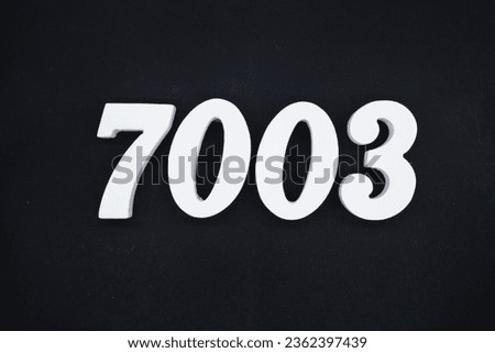 Black for the background. The number 7003 is made of white painted wood.