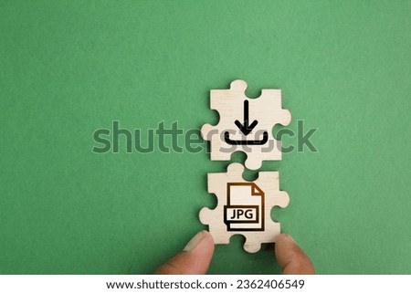 wooden puzzle with save jpeg file icon. the concept of saving a file or downloading a file in cyberspace or in a computer