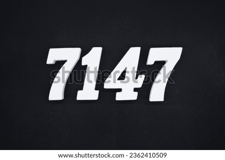 Black for the background. The number 7147 is made of white painted wood.