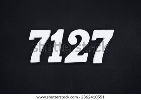 Black for the background. The number 7127 is made of white painted wood.
