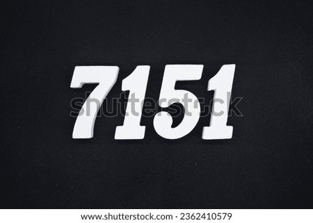 Black for the background. The number 7151 is made of white painted wood.