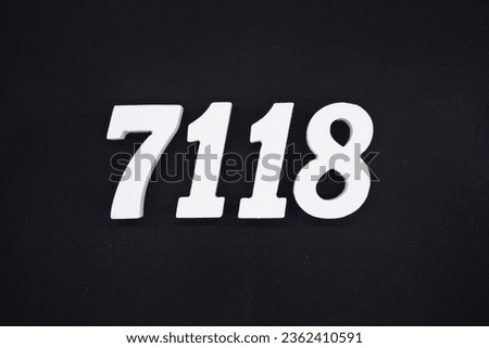 Black for the background. The number 7118 is made of white painted wood.