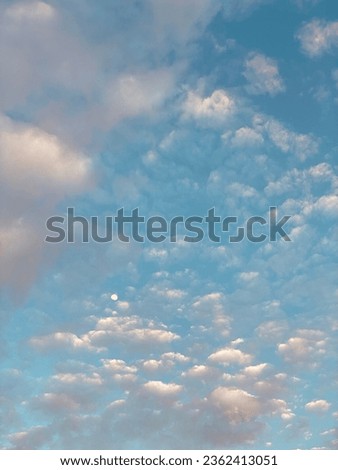 Blue sky with clouds and moon