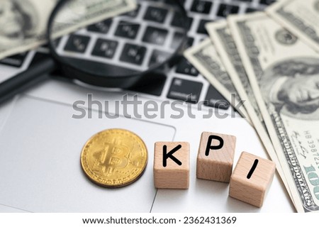 Finance and economics concept. On the table are money, a calculator, a notebook and cubes with the inscription - KPI