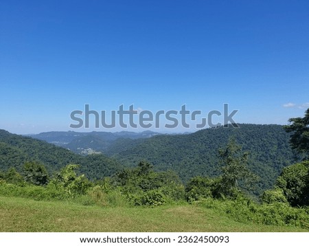 Picture of green mountains with blue sky.