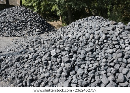 Large pile of coal rocks outdoors taken on a sunny day Royalty-Free Stock Photo #2362452759
