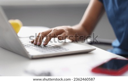 Female hands typing on the laptop keyboard at workplace. Copywriting profession training concept