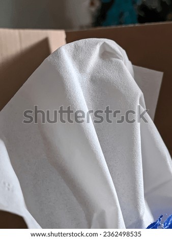 close up of white tissue in a cardboard box