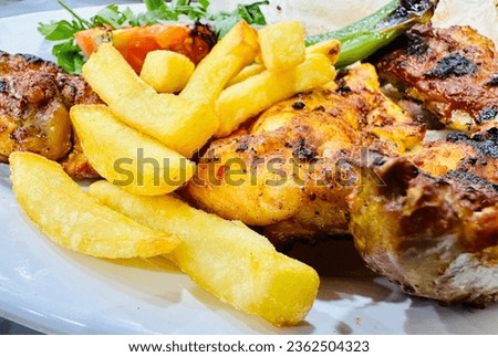 Grilled chicken, fries and salad. Delicious syrian food close up shot.