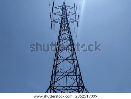 the pylon outline, Very High Voltage Power Lines (Indonesia : SUTET) on blue sky Royalty-Free Stock Photo #2362519099