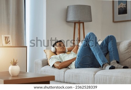 Man on sofa with headphones, relax and sleep in living room with chill sound, streaming or podcast meditation. Zen, music and person on couch with earphones, peace and calm audio for wellness in home