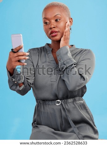 Phone, selfie and black woman beauty on app or video call isolated in studio blue background with style. Connection, African and influencer person or content creator live streaming on social media