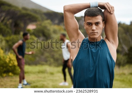 Stretching, fitness and portrait of a man outdoor for health and wellness. Serious runner, athlete or sports person in nature park to start exercise, workout or training with arm muscle warm up