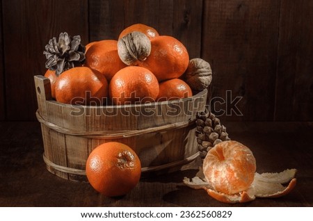 tangerines in a box on a dark wooden background