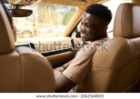 Married African American couple communicates cheerfully in a comfortable car