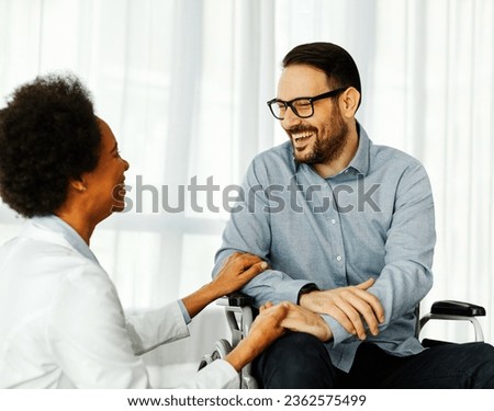 Portrait of a young man in wheelchair and his doctor at home or in hospital, person with disability, people with paraplegia, man with chronic health condition