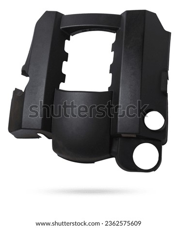 Black plastic engine cover on a white background in a photo studio as a separate spare part for sale at an auto-parsing or for replacement when repairing a car in the service. Royalty-Free Stock Photo #2362575609