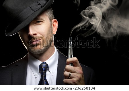 male smoking a vapor cigarette as an alternative to tobacco Royalty-Free Stock Photo #236258134