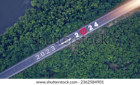 New year 2023 or 2024, planning concept, start of success, text 2024 written in the middle of a paved road. New year plans, goals, challenges, resolutions.