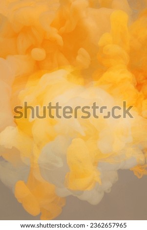 Abstract smoke background. Ink colors blot in water. Yellow, white, beige tone.