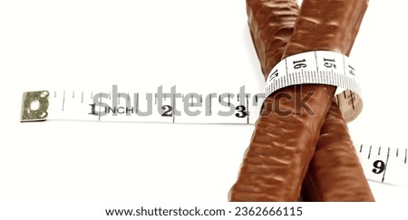 dieting concept milk chocolate with tape measure on a table no people stock image stock photo