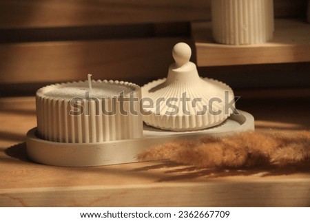 plaster trincket tray with paraffin sand candle product photography Royalty-Free Stock Photo #2362667709