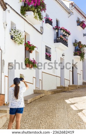 Young Woman Taking Pictures During Vacations In A Greek City