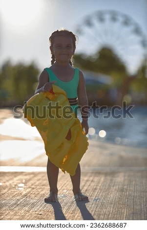 baby swimming life jacket in the hands of a girl