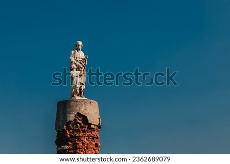 statue of Saint Joseph against a blue sky 