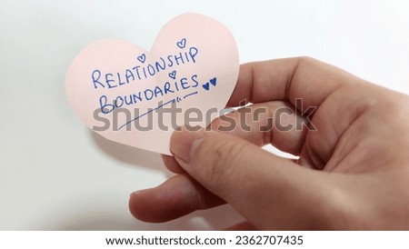 A heart shaped note with the words Relationship Boundaries Royalty-Free Stock Photo #2362707435