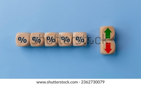 Cube block with percentage symbol icon. Interest rate financial and mortgage rates concept. Wood cube change arrow down to up. Interest rate, stocks, ranking. Business and finance concept.