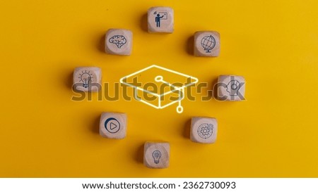 Knowledge and teaching. Wooden cubes with graduation and education symbols. Success and necessary skills in graduation or education. 
