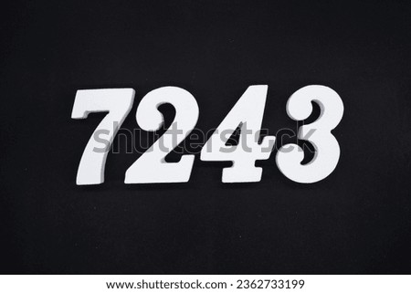 Black for the background. The number 7243 is made of white painted wood.