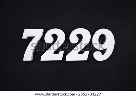 Black for the background. The number 7229 is made of white painted wood.