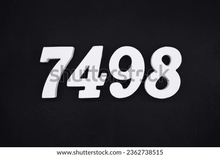 Black for the background. The number 7498 is made of white painted wood.
