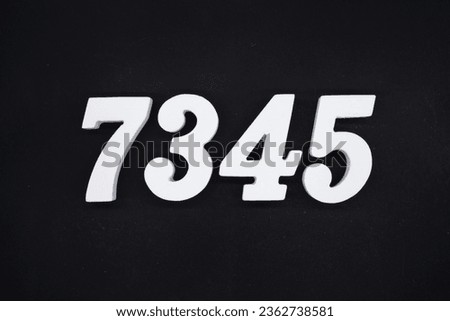 Black for the background. The number 7345 is made of white painted wood.