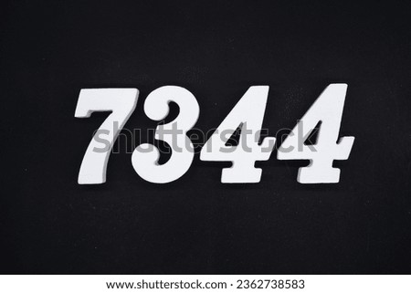 Black for the background. The number 7344 is made of white painted wood.