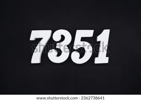 Black for the background. The number 7351 is made of white painted wood.