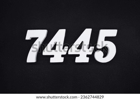 Black for the background. The number 7445 is made of white painted wood.