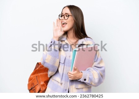 Young beautiful student woman isolated on white background shouting with mouth wide open to the side