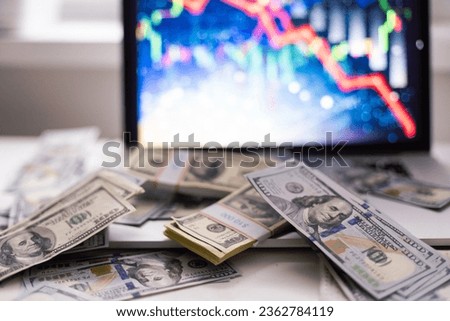 Different dollar bills and business graph in the background. Natural photo.