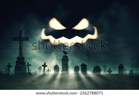 Creepy cemetery with zombies at night and Jack-o'-lantern spooky face in the sky, Halloween and horror background