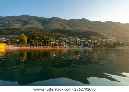View of the city of Shiroka from the lake on a traditional boat on a sightseeing excursion from Shkoder. Albania